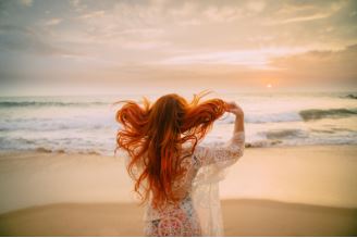 woman tossing her red hair behind shoulder
