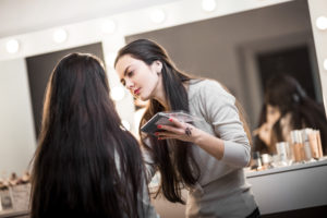 makeup artist doing makeup on a client